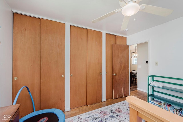 47 Habig Rd, Indianapolis, IN 46217 - bedroom with multiple closets, light wood-style floors, and a ceiling fan