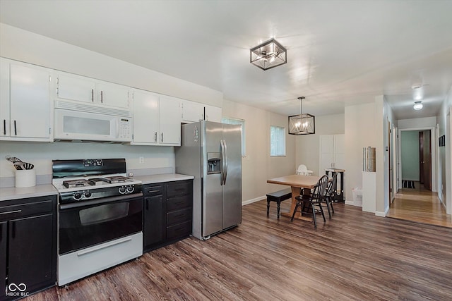 47 Habig Rd, Indianapolis, IN 46217 - kitchen with white microwave, gas range, stainless steel fridge, and light countertops