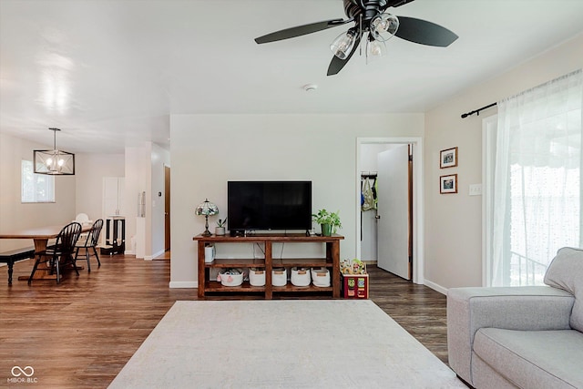 47 Habig Rd, Indianapolis, IN 46217 - living room with dark wood-type flooring, a ceiling fan, and a chandelier