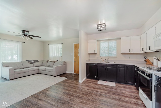 47 Habig Rd, Indianapolis, IN 46217 - kitchen featuring black dishwasher, gas range, white cabinetry, light countertops, and dark wood-type flooring