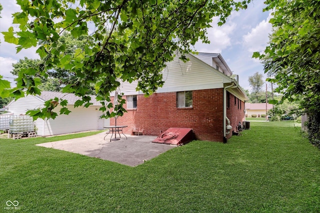 47 Habig Rd, Indianapolis, IN 46217 - back of house featuring a patio, a lawn, and brick siding