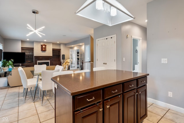 2847 Macintosh, Columbus, IN 47201 - kitchen with light tile patterned flooring, a large fireplace, a center island, open floor plan, and recessed lighting
