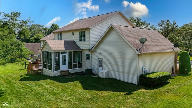2847 Macintosh, Columbus, IN 47201 - back of property with a sunroom, a lawn, and a shingled roof