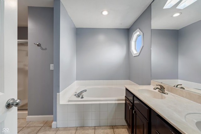 2847 Macintosh, Columbus, IN 47201 - bathroom with a skylight, a garden tub, double vanity, and tile patterned flooring