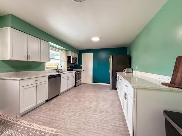 8883 W Hilltop Ln, Elwood, IN 46036 - kitchen with stainless steel appliances, white cabinets, light wood-type flooring, and recessed lighting