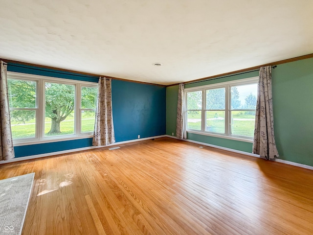 8883 W Hilltop Ln, Elwood, IN 46036 - spare room featuring ornamental molding and wood finished floors