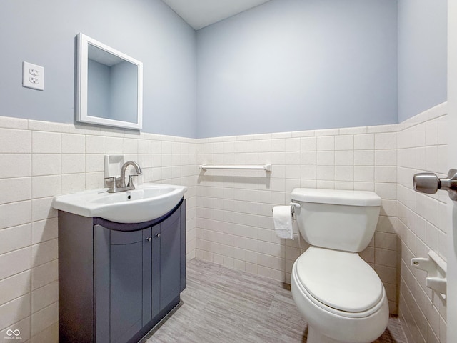 8883 W Hilltop Ln, Elwood, IN 46036 - half bath with tile walls, vanity, and a wainscoted wall