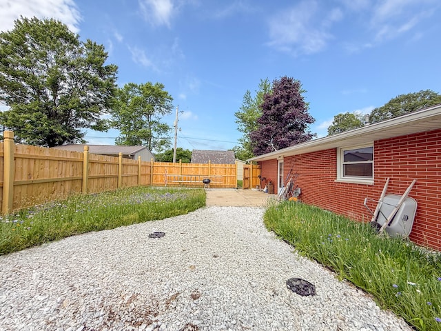 8883 W Hilltop Ln, Elwood, IN 46036 - fenced backyard featuring a patio area
