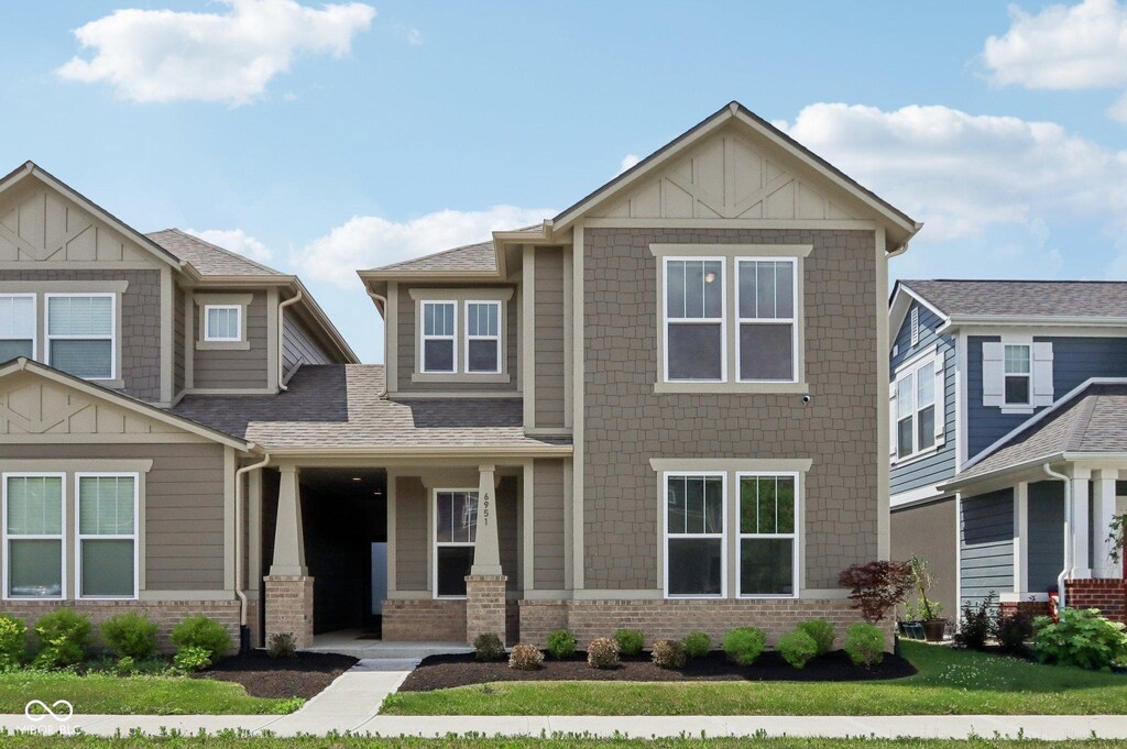 6951 Antiquity Dr, Carmel, IN 46033 - craftsman inspired home with board and batten siding, brick siding, a front lawn, and roof with shingles