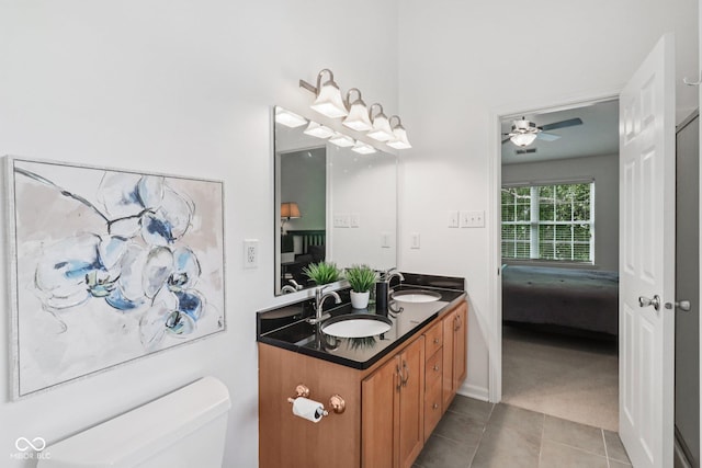 10792 Sawgrass Dr, Fishers, IN 46037 - full bathroom with double vanity, ensuite bath, a ceiling fan, and tile patterned flooring