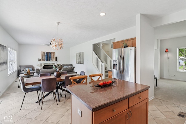 10792 Sawgrass Dr, Fishers, IN 46037 - kitchen featuring stainless steel fridge with ice dispenser, plenty of natural light, open floor plan, light tile patterned flooring, and recessed lighting