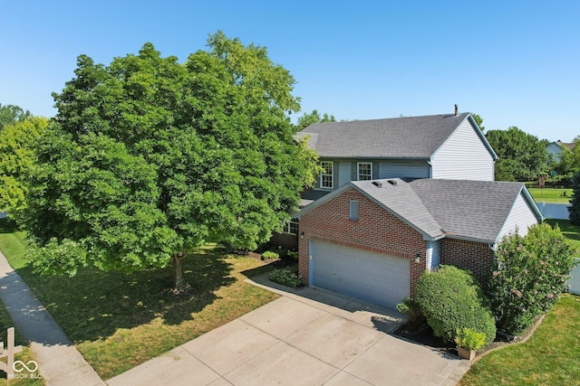 10792 Sawgrass Dr, Fishers, IN 46037 - view of front facade with brick siding, an attached garage, concrete driveway, roof with shingles, and a front lawn