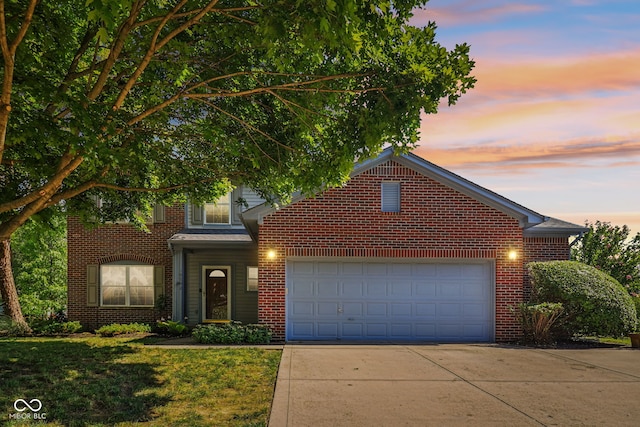 10792 Sawgrass Dr, Fishers, IN 46037 - traditional-style home featuring driveway, an attached garage, brick siding, and a lawn