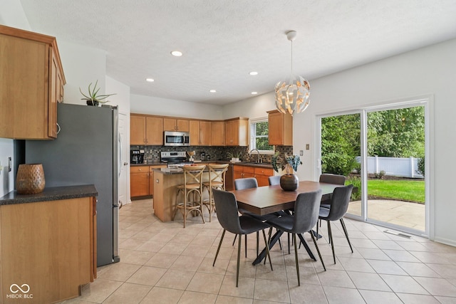 10792 Sawgrass Dr, Fishers, IN 46037 - dining area featuring light tile patterned flooring, a chandelier, and recessed lighting