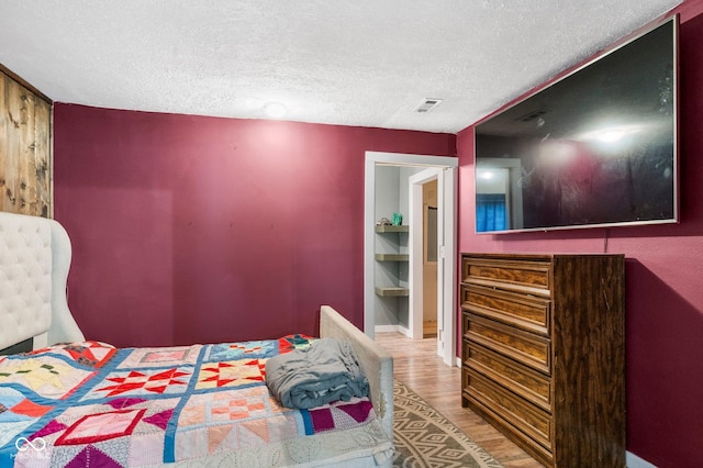 43 W Main St, North Vernon, IN 47265 - bedroom featuring wood finished floors and a textured ceiling