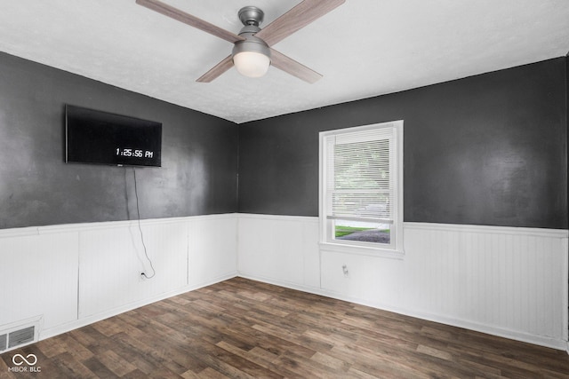 43 W Main St, North Vernon, IN 47265 - spare room with wainscoting, ceiling fan, and dark wood-style flooring