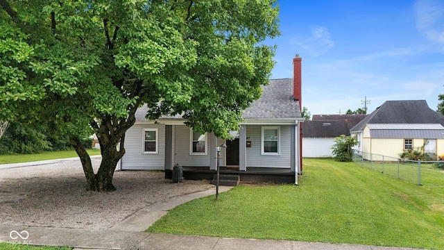 43 W Main St, North Vernon, IN 47265 - view of front of house with covered porch, a chimney, and roof with shingles