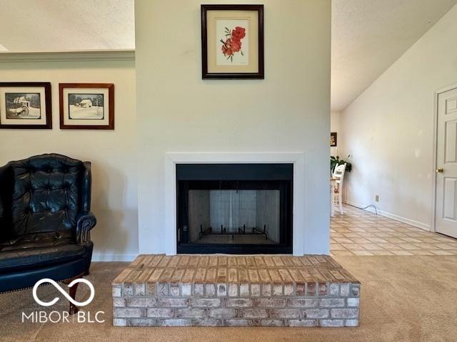 1042 W Oak Hill Xing, Crawfordsville, IN 47933 - detailed view of a brick fireplace and carpet flooring