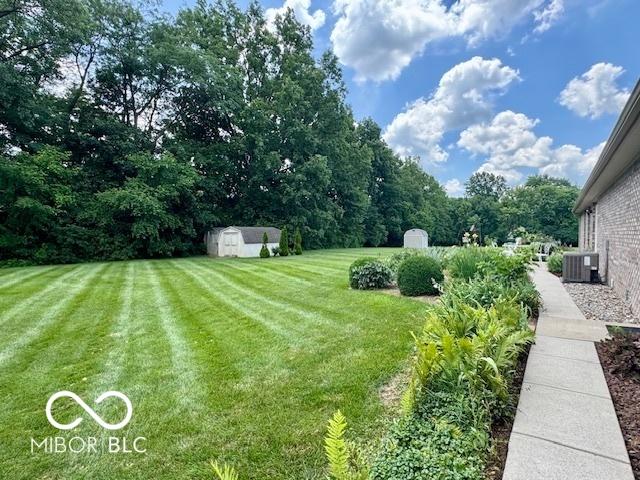 1042 W Oak Hill Xing, Crawfordsville, IN 47933 - view of grassy yard featuring a storage unit