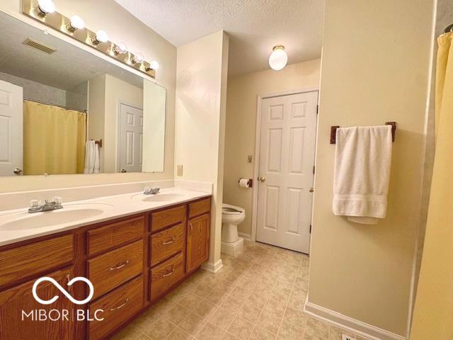 1042 W Oak Hill Xing, Crawfordsville, IN 47933 - full bath with double vanity and a shower with shower curtain