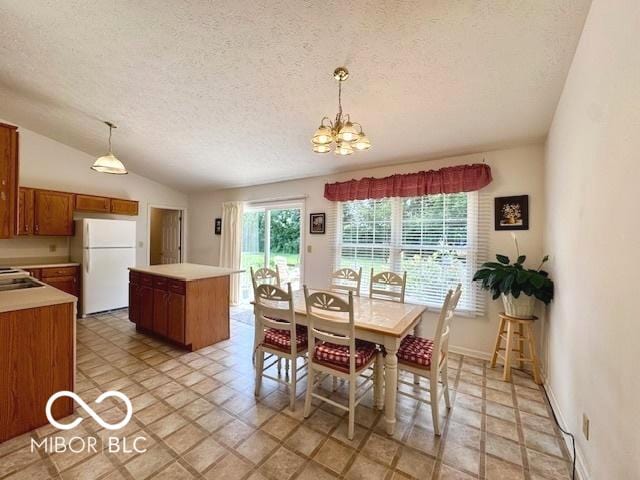 1042 W Oak Hill Xing, Crawfordsville, IN 47933 - dining area with a textured ceiling, a chandelier, lofted ceiling, and light stone finish flooring