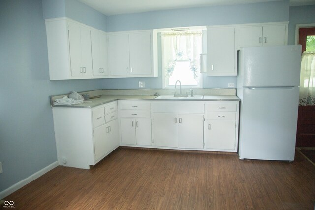 12 E N St, New Palestine, IN 46163 - kitchen featuring freestanding refrigerator, light countertops, white cabinets, and dark wood-style flooring