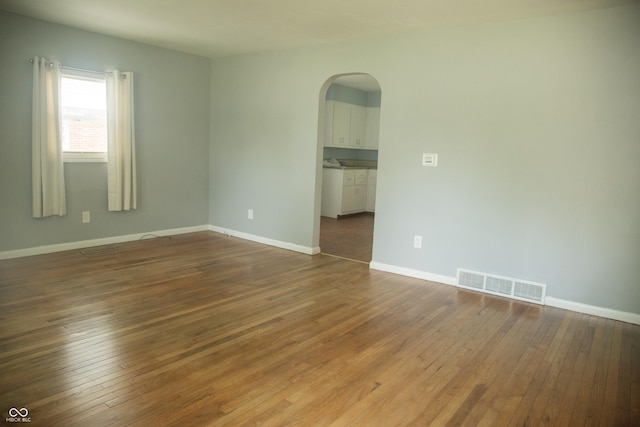 12 E N St, New Palestine, IN 46163 - empty room featuring arched walkways and wood-type flooring