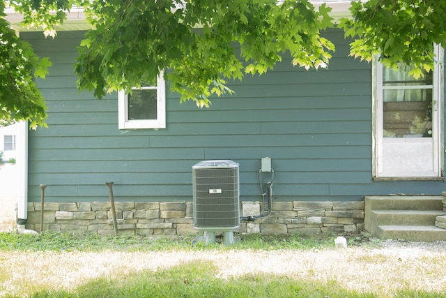 12 E N St, New Palestine, IN 46163 - exterior view of a central air condition unit and entry steps