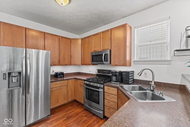 2232 N Park Ave, Indianapolis, IN 46205 - kitchen featuring appliances with stainless steel finishes, dark countertops, dark wood finished floors, and brown cabinets