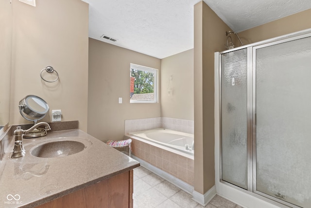 2232 N Park Ave, Indianapolis, IN 46205 - bathroom featuring a stall shower, a bath, vanity, a textured ceiling, and tile patterned flooring