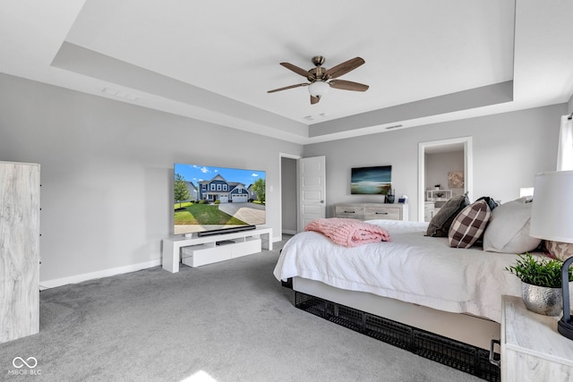 9978 Trafford Ct, Mccordsville, IN 46055 - carpeted bedroom featuring a tray ceiling and a ceiling fan