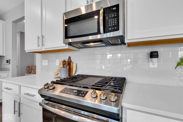 9978 Trafford Ct, Mccordsville, IN 46055 - kitchen with stainless steel appliances, light countertops, white cabinetry, and tasteful backsplash