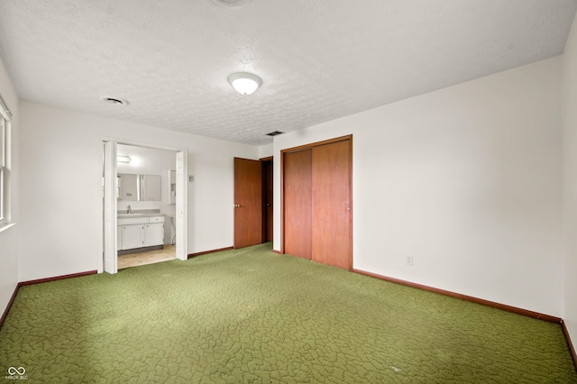 1620 W 300 S, Franklin, IN 46131 - unfurnished bedroom with a closet, carpet floors, connected bathroom, and a textured ceiling