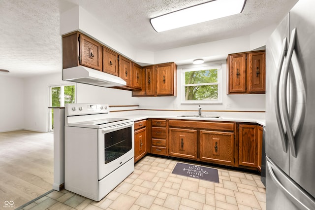 1620 W 300 S, Franklin, IN 46131 - kitchen with freestanding refrigerator, white electric range oven, under cabinet range hood, a textured ceiling, and brown cabinets