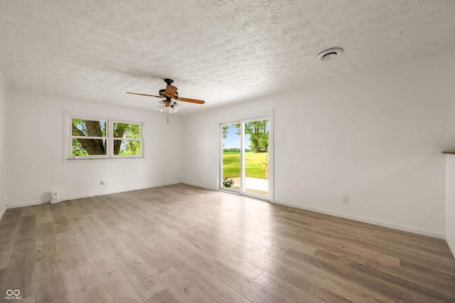 1620 W 300 S, Franklin, IN 46131 - empty room with plenty of natural light, ceiling fan, wood finished floors, and a textured ceiling