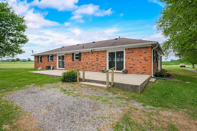 1620 W 300 S, Franklin, IN 46131 - rear view of house with a patio, a lawn, and brick siding