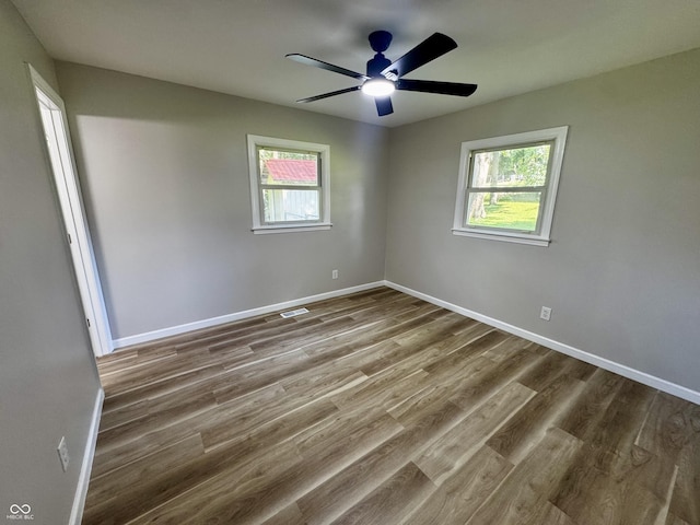 84 S Schenck Rd, Crawfordsville, IN 47933 - unfurnished room featuring healthy amount of natural light, wood finished floors, and ceiling fan