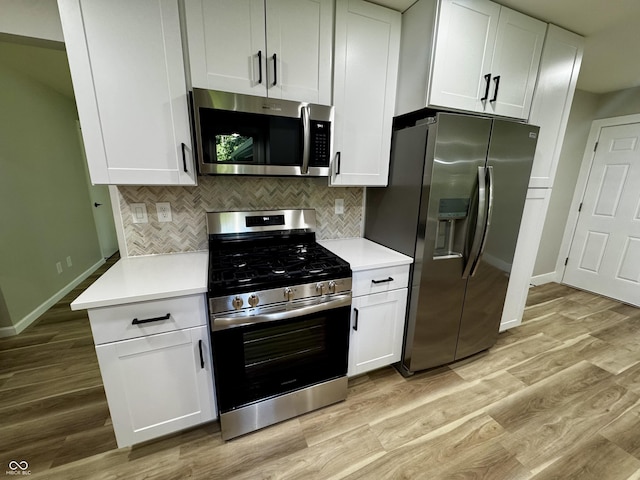 84 S Schenck Rd, Crawfordsville, IN 47933 - kitchen with stainless steel appliances, light wood finished floors, decorative backsplash, light countertops, and white cabinets