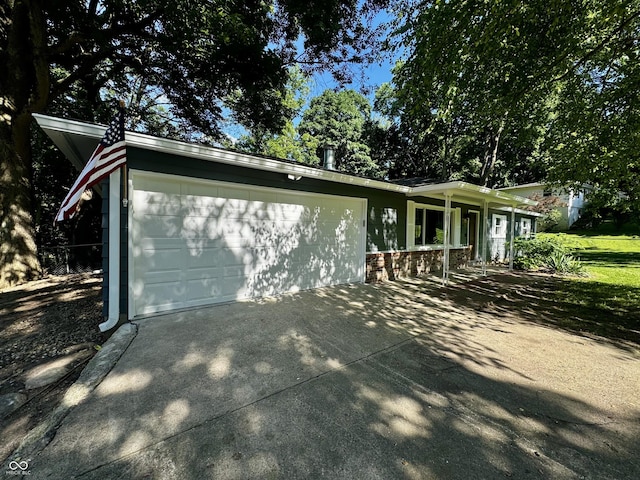 84 S Schenck Rd, Crawfordsville, IN 47933 - view of side of property featuring driveway and a garage