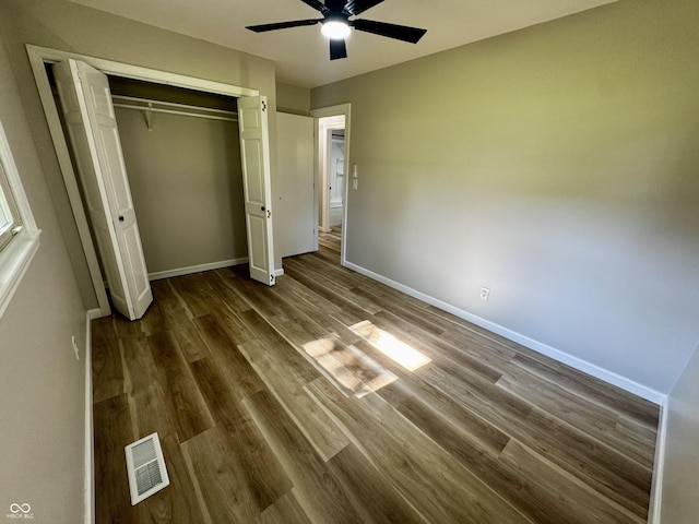 84 S Schenck Rd, Crawfordsville, IN 47933 - unfurnished bedroom featuring dark wood-style floors, a closet, and a ceiling fan