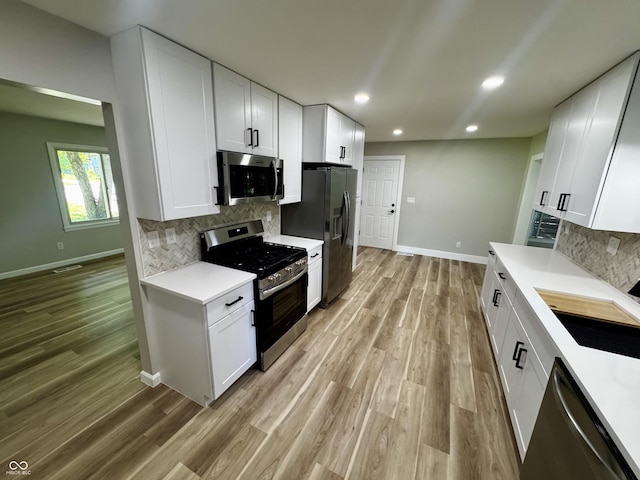 84 S Schenck Rd, Crawfordsville, IN 47933 - kitchen featuring appliances with stainless steel finishes, light countertops, light wood-style flooring, recessed lighting, and tasteful backsplash