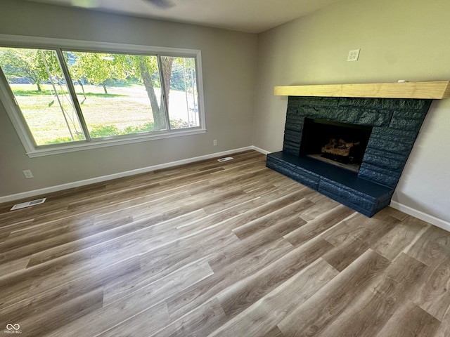 84 S Schenck Rd, Crawfordsville, IN 47933 - unfurnished living room with a stone fireplace and wood finished floors