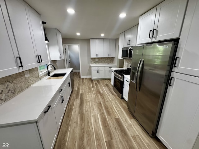 84 S Schenck Rd, Crawfordsville, IN 47933 - kitchen featuring appliances with stainless steel finishes, light wood-style flooring, tasteful backsplash, white cabinets, and recessed lighting