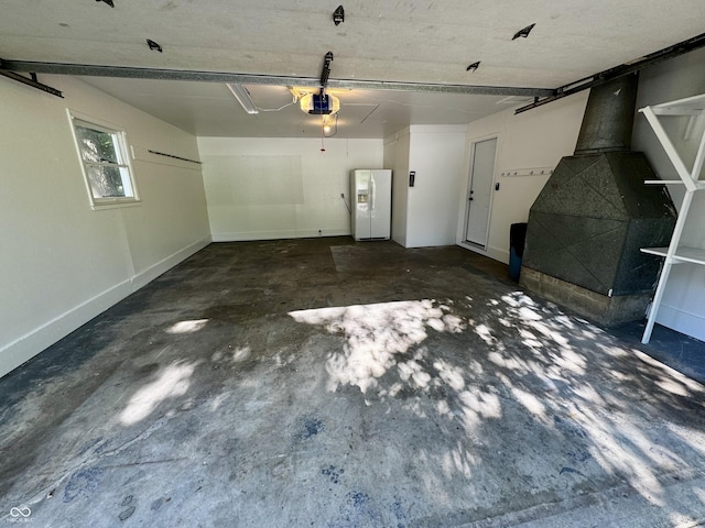84 S Schenck Rd, Crawfordsville, IN 47933 - garage featuring white fridge with ice dispenser and a garage door opener