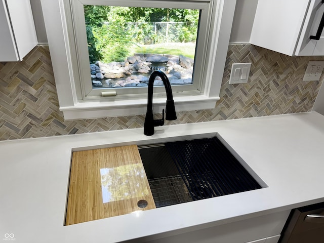 84 S Schenck Rd, Crawfordsville, IN 47933 - kitchen view of backsplash, white cabinetry, and light countertops