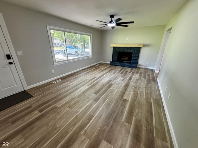 84 S Schenck Rd, Crawfordsville, IN 47933 - unfurnished living room featuring a ceiling fan, wood finished floors, and a fireplace