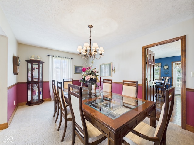 1014 Gray Squirrel Dr, Pendleton, IN 46064 - dining room with a chandelier, light colored carpet, and a textured ceiling