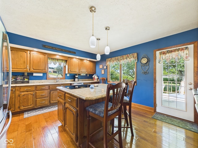 1014 Gray Squirrel Dr, Pendleton, IN 46064 - kitchen with light countertops, healthy amount of natural light, brown cabinets, and a textured ceiling