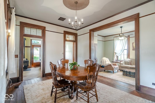 9665 N County Rd 250 E, Frankfort, IN 46041 - dining area with wood-type flooring, ornamental molding, healthy amount of natural light, and a chandelier
