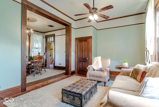 9665 N County Rd 250 E, Frankfort, IN 46041 - living room featuring crown molding, wood finished floors, a chandelier, and a ceiling fan